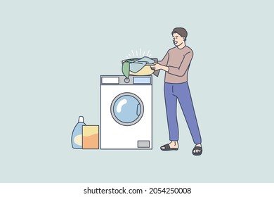 Smiling young man near washing machine do laundry wash clothes with soap powder detergent. Happy male perform housework at laundromat. Domestic chores concept. Flat vector illustration. 