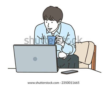 Smiling young man operating a PC in plain clothes
