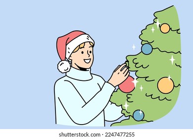Smiling young man in Santa hat decorate Christmas tree with colorful balls. Happy guy have fun with fir-tree decoration at home celebrate New Year. Vector illustration. 