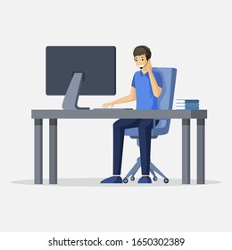 Smiling young man sitting at the table in front of computer with earpiece and microphone on head vector flat illustration. Support, freelance, virtual office or outsourcing cartoon character.