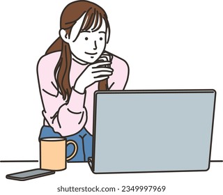 Smiling young woman operating a PC in plain clothes
