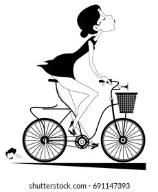 Smiling young woman rides a bike and looks healthy and happy