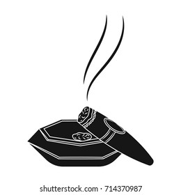 A smoking cigar in an ashtray. Smoking cigars single icon in black style vector symbol stock illustration web.