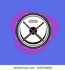 
snare drum and there are two drum sticks in the middle