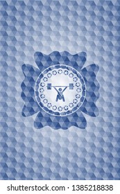 snatch, weightlifting icon inside blue emblem with geometric pattern.