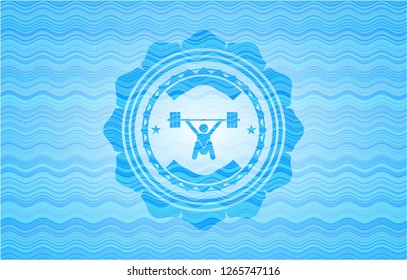 snatch, weightlifting icon inside sky blue water style emblem.