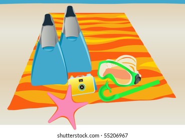 Snorkeling Equipment - Snorkel gear on colorful beach towel.