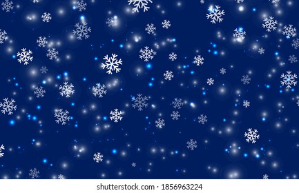 Snow background. Winter snowfall. White snowflakes on blue sky. Christmas background. Falling snow.