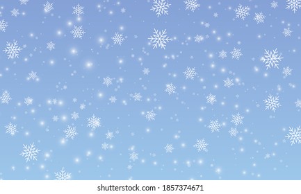 Snow background. Winter snowfall. White snowflakes on blue sky. Christmas background. Falling snow.