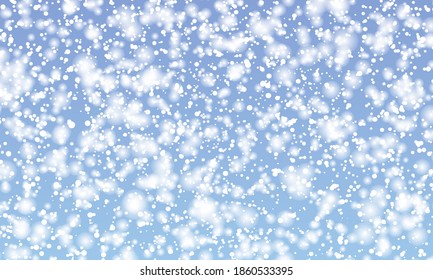 Snow background. Winter snowfall. White snowflakes on blue sky. Christmas background. Falling snow.