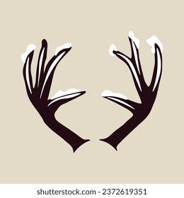 Snow covered deer horns on beige background
