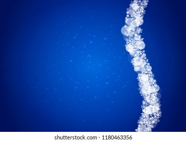 Snow frame with white snowflakes for Christmas and New Year celebration on blue background with sparkles. Horizontal snow frame for banners, gift coupon, voucher, ads, party event. Falling frosty snow