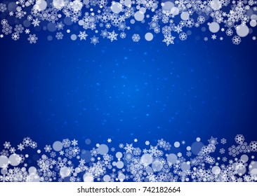 Snow frame with white snowflakes for Christmas and New Year celebration on blue background with sparkles. Horizontal snow frame for banners, gift coupon, voucher, ads, party event. Falling frosty snow