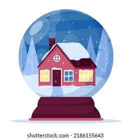 A snow globe with a house on the background of a snow-covered forest.