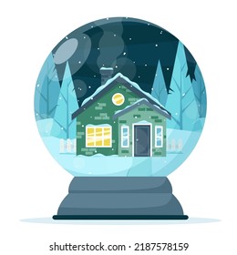 A snow globe with a house on the background of a snow-covered forest.