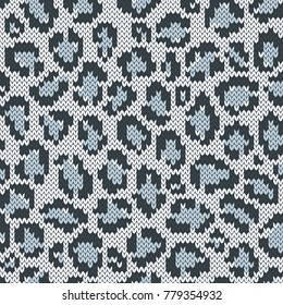 Snow leopard jacquard seamless pattern. Knitted texture. Winter background. Vector illustration.