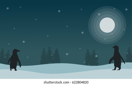 Snow scenery at night with penguin silhouettes