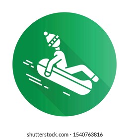 Snow tubing green flat design long shadow glyph icon. Winter extreme sport, risky activity and adventure. Cold season outdoor leisure for children and adults. Vector silhouette illustration