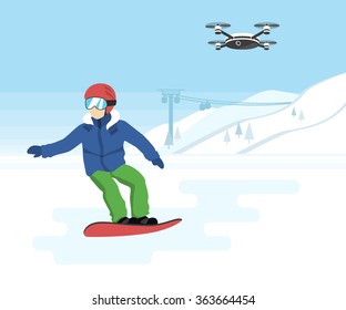 Snowboarding and remote drone with camera. Young snowboarder and quadrocopter with camera flying in the sky and recording a video of active sport life