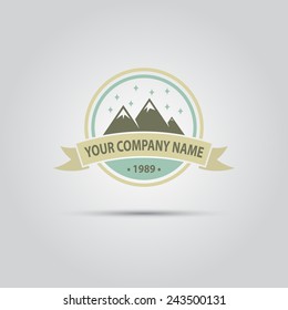 snow-covered mountains and ribbon for text round vector logo for travel company