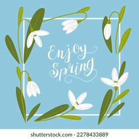 Snowdrop flower background and enjoy spring lettering in a frame. First spring flowers.