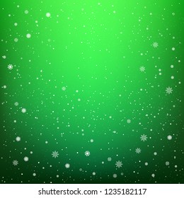 Snowfall on dark green background. Winter sky with snow. Frosty close-up wintry snowflakes. Ice shape pattern. Christmas holiday decoration backdrop