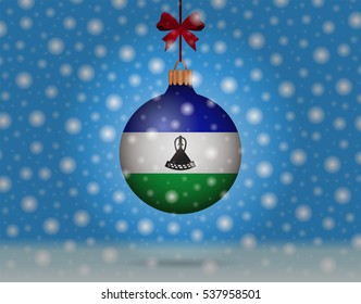 Snowfall and ornament with flag of Lesotho