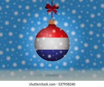 Snowfall and ornament with flag of Netherlands