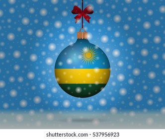 Snowfall and ornament with flag of Rwanda