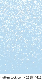 Snowfall overlay christmas background. Subtle flying snow flakes and stars on light blue winter backdrop. Festive snowfall overlay. Vertical vector illustration.