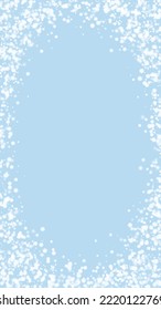 Snowfall overlay christmas background. Subtle flying snow flakes and stars on light blue winter backdrop. Festive snowfall overlay. Vertical vector illustration.