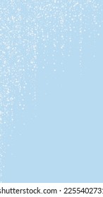 Snowfall overlay christmas background. Subtle flying snow flakes and stars on light blue winter backdrop. Festive snowfall overlay. Vertical vector illustration.