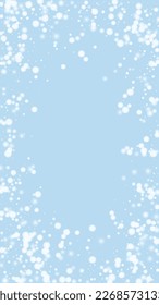 Snowfall overlay christmas background. Subtle flying snow flakes and stars on light blue winter backdrop. Festive snowfall overlay. Vertical vector illustration.