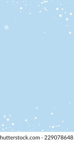 Snowfall overlay christmas background. Subtle flying snow flakes and stars on light blue winter backdrop. Festive snowfall overlay. Vertical vector illustration.