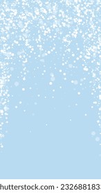 Snowfall overlay christmas background. Subtle flying snow flakes and stars on light blue winter backdrop. Festive snowfall overlay. Vertical vector illustration.