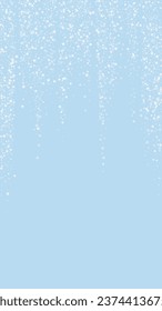 Snowfall overlay christmas background. Subtle flying snow flakes and stars on light blue winter backdrop. Festive snowfall overlay. Vertical vector illustration.