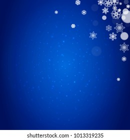 Snowflake border for Christmas and New Year celebration. Holiday snowflake border on blue background with sparkles. For banners, gift coupons, vouchers, ads, party events. Falling frosty snow.