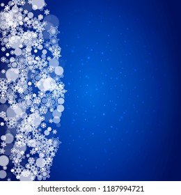 Snowflake border for Christmas and New Year celebration. Holiday snowflake border on blue background with sparkles. For banners, gift coupons, vouchers, ads, party events. Falling frosty snow.