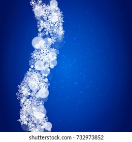 Snowflake border for Christmas and New Year celebration. Holiday snowflake border on blue background with sparkles. For banners, gift coupons, vouchers, ads, party events. Falling frosty snow.
