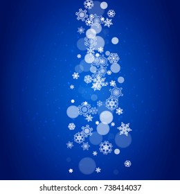 Snowflake border for Christmas and New Year celebration. Holiday snowflake border on blue background with sparkles. For banners, gift coupons, vouchers, ads, party events. Falling frosty snow.