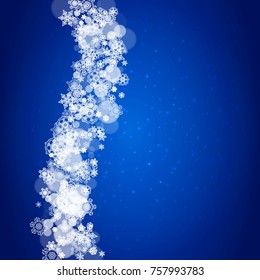 Snowflake border for Christmas and New Year celebration. Holiday snowflake border on blue background with sparkles. For banners, gift coupons, vouchers, ads, party events. Falling frosty snow.