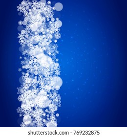 Snowflake border for Christmas and New Year celebration. Holiday snowflake border on blue background with sparkles. For banners, gift coupons, vouchers, ads, party events. Falling frosty snow.