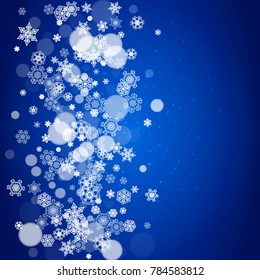 Snowflake border for Christmas and New Year celebration. Holiday snowflake border on blue background with sparkles. For banners, gift coupons, vouchers, ads, party events. Falling frosty snow.