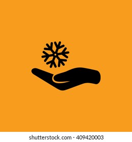 Snowflake on hand icon