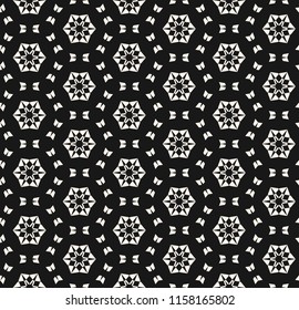 Snowflake seamless pattern. Vector abstract black and white geometric texture with small floral shapes, snow flakes, delicate mesh. Modern monochrome background. Winter holiday theme. Repeat design