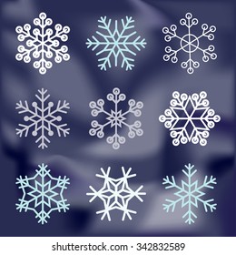 Snowflake set on dark blue blurred background. Winter Holidays Decoration design elements.