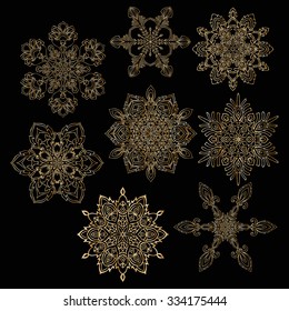 Snowflake set. Vector hand drawn decorative illustration in gold and black colors