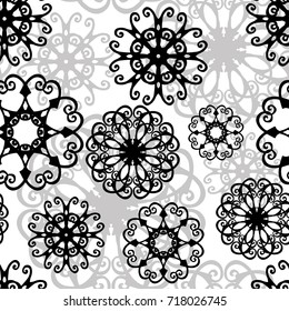 Snowflakes. Abstract black and white pattern. Stylized black and gray snowflakes on a white background. Monochrome tracery background. Seamless texture. Christmas. New Year. Vector.