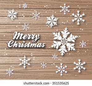 Snowflakes against grunge wooden background-Winter holidays background