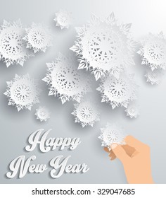 Snowflakes background for winter and New Year, christmas theme. Snow, christmas, snowflake background, snowflake winter. 3D paper snowflakes. Happy New Year 2016. Silver snowflake. Snowflakes and hand